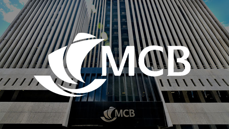 MCB logo overlaying imagery of the MCB building.